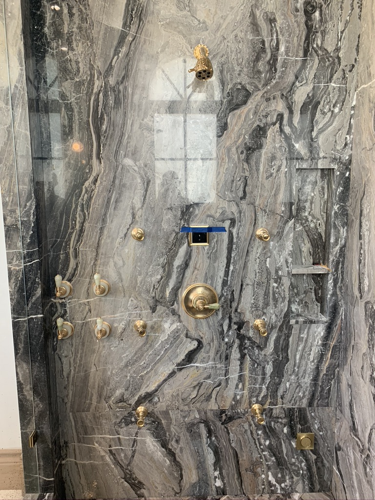 Custom brass spa shower set in stone slab